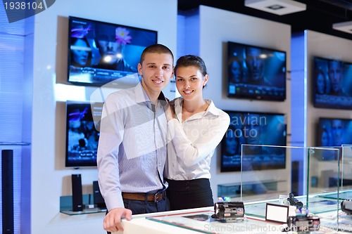 Image of Young couple in consumer electronics store