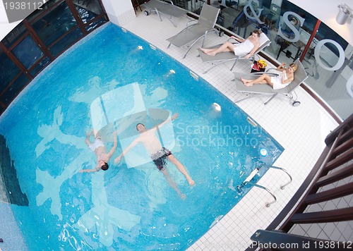 Image of young people group at spa swimming pool