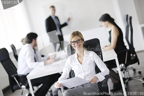 Image of business woman with her staff in background