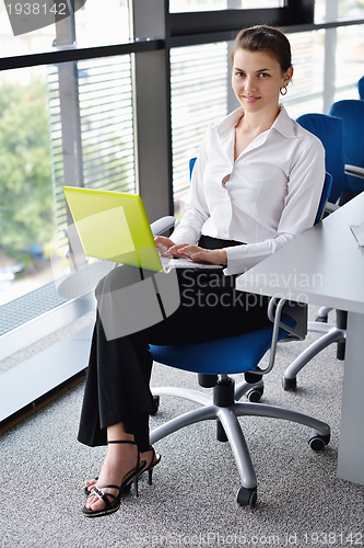 Image of Young pretty business woman with notebook in the office