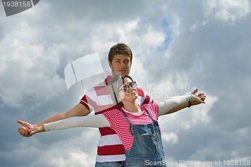 Image of Portrait of romantic young couple smiling together outdoor