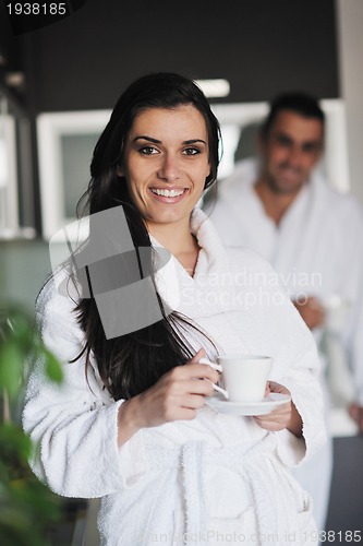 Image of Young love couple taking fresh morning cup of coffee