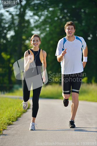 Image of Young couple jogging at morning