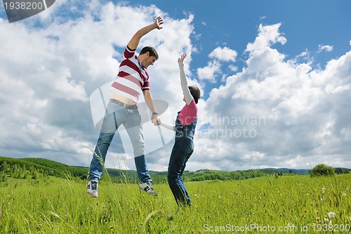 Image of Portrait of romantic young couple smiling together outdoor