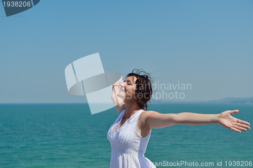 Image of happy young woman with spreading arms to sky