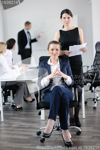 Image of business woman with her staff in background