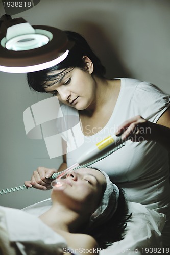 Image of woman with facial mask in cosmetic studio