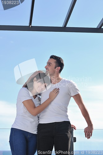 Image of couple relaxing on balcony