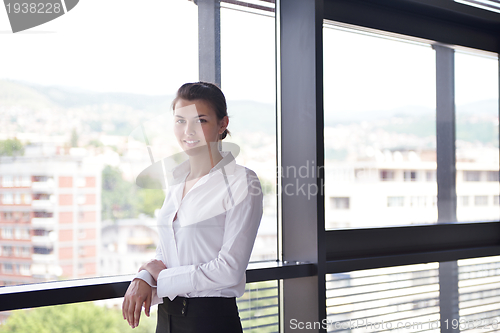 Image of Young pretty business woman with notebook in the office
