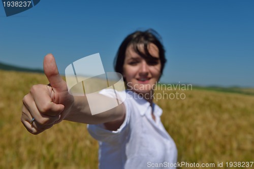 Image of young woman in wheat field at summer