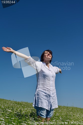 Image of young woman in wheat field at summer