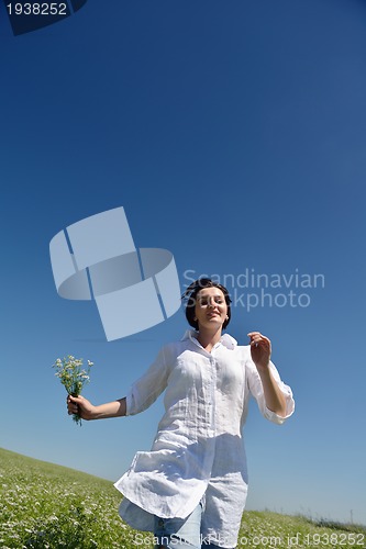 Image of Young happy woman in green field
