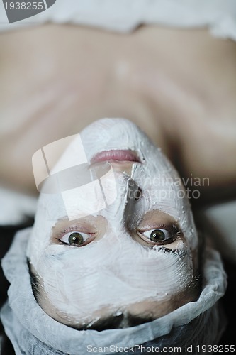 Image of woman with facial mask in cosmetic studio
