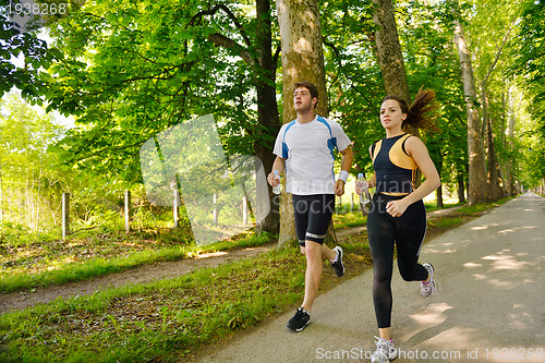 Image of Young couple jogging