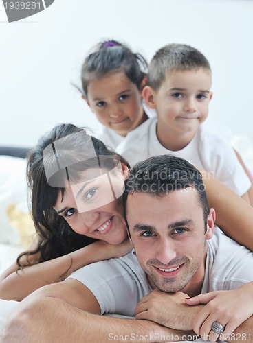 Image of happy young Family in their bedroom