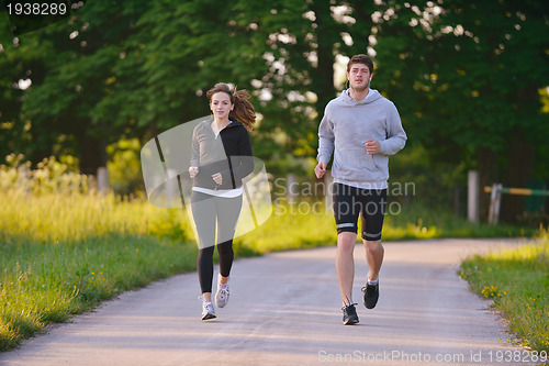 Image of Young couple jogging