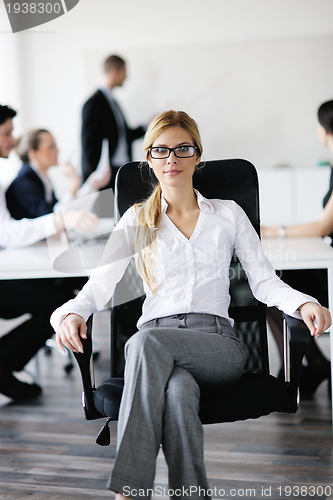 Image of business woman with her staff in background