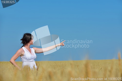 Image of young woman in wheat field at summer