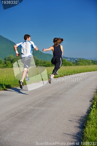 Image of Young couple jogging at morning