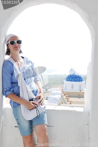 Image of Greek woman on the streets of Oia, Santorini, Greece