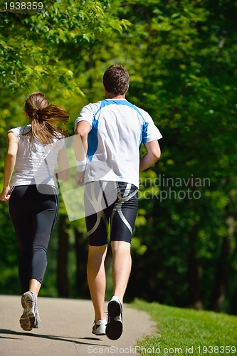 Image of Young couple jogging