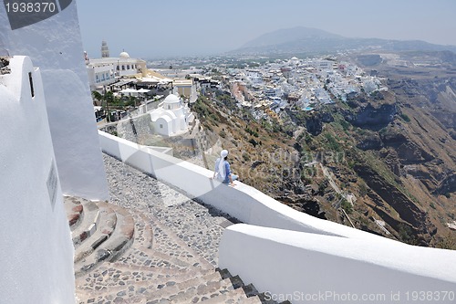 Image of Greek woman on the streets of Oia, Santorini, Greece