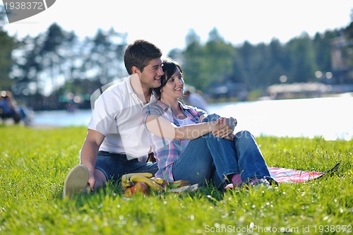 Image of happy young couple having a picnic outdoor