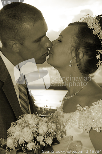Image of wedding kiss in sepia colorous