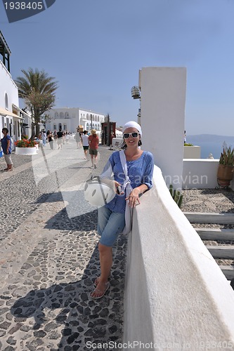 Image of Greek woman on the streets of Oia, Santorini, Greece