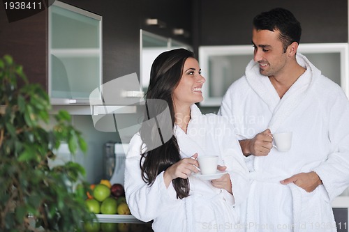 Image of Young love couple taking fresh morning cup of coffee