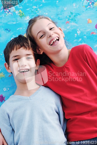 Image of portrait of happy brother and sister at home