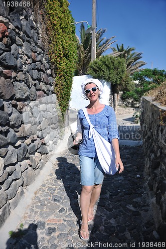 Image of Greek woman on the streets of Oia, Santorini, Greece