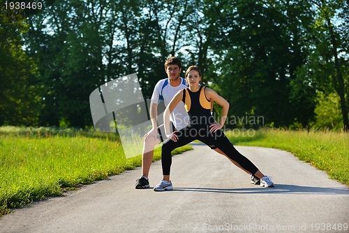 Image of Couple doing stretching exercise  after jogging