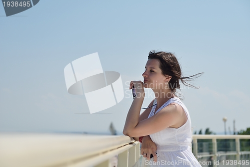 Image of young woman with spreading arms to sky