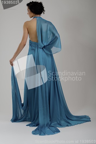 Image of elegant woman in fashionable dress posing in the studio