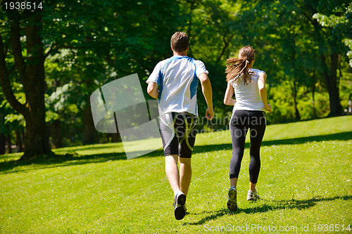 Image of Young couple jogging