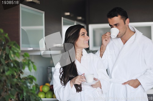 Image of Young love couple taking fresh morning cup of coffee