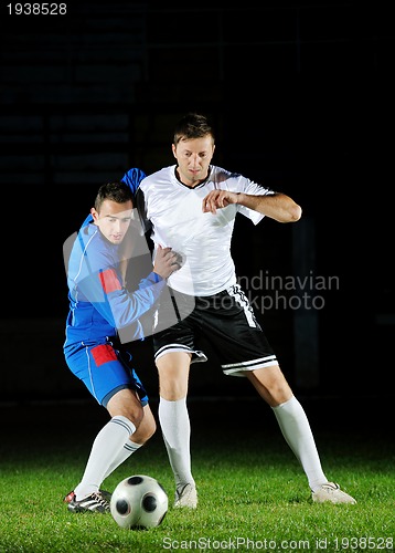 Image of football players in action for the ball