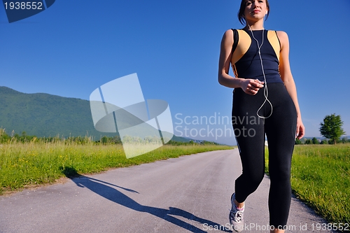 Image of Young beautiful  woman jogging