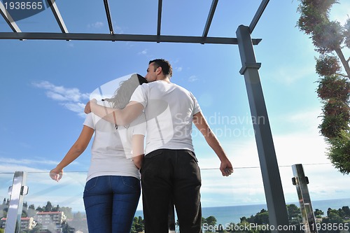 Image of couple relaxing on balcony