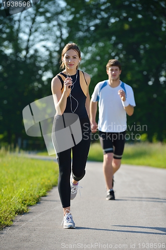 Image of Young couple jogging at morning