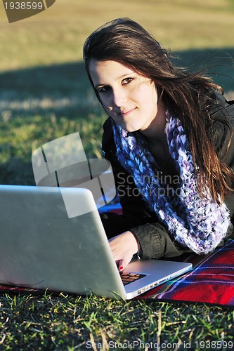 Image of young teen girl work on laptop outdoor