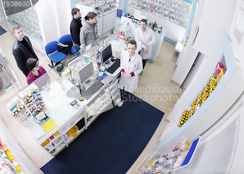 Image of pharmacist suggesting medical drug to buyer in pharmacy drugstor