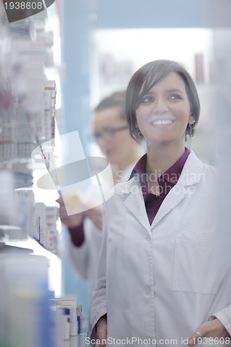 Image of pharmacist chemist woman standing in pharmacy drugstore