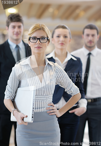 Image of business woman standing with her staff at conference