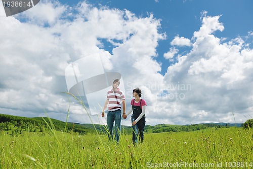 Image of Portrait of romantic young couple smiling together outdoor