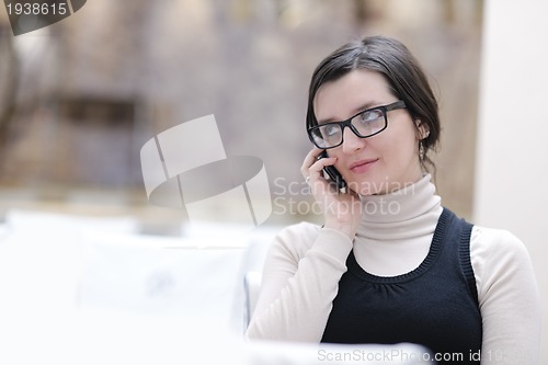 Image of young woman  talking on a phone