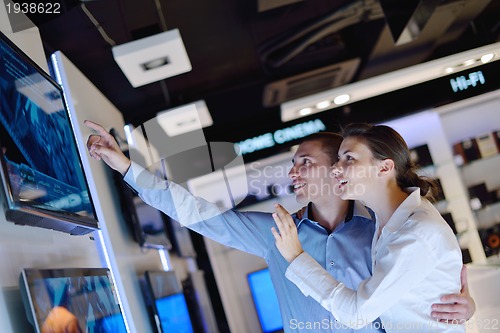 Image of Young couple in consumer electronics store