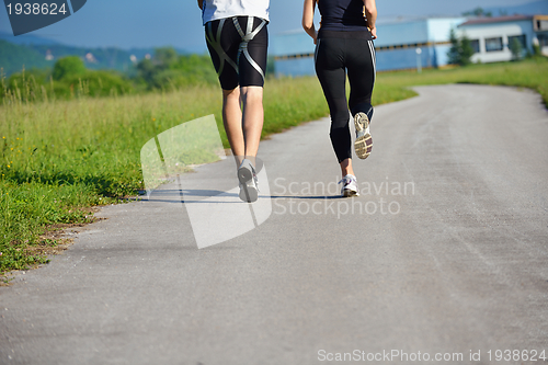 Image of Young couple jogging at morning