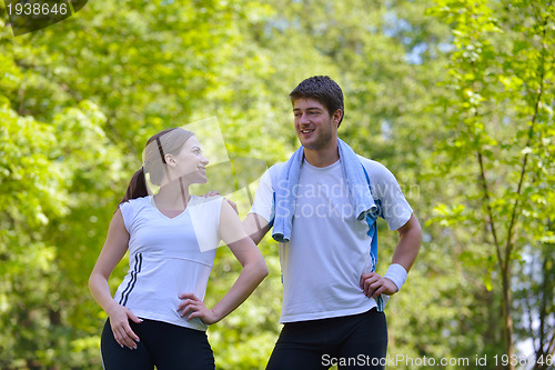 Image of Couple doing stretching exercise  after jogging